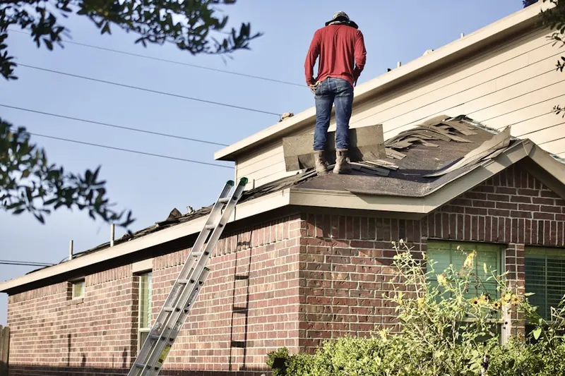 Professional roofer working on a residential roof in Copperfield Southcreek Village